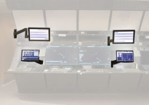Monitor arms mounted to FAA air traffic control console